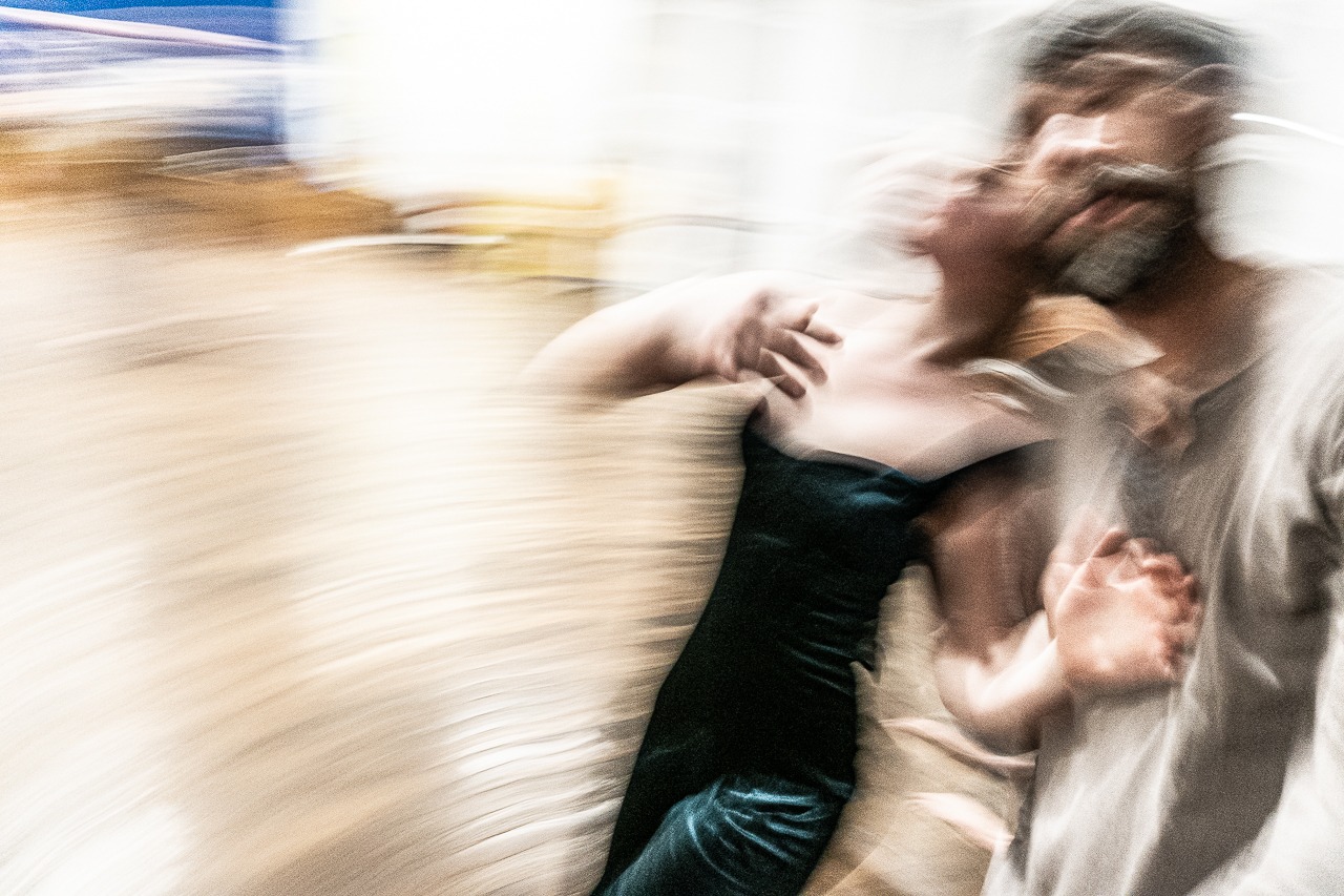 Zwei Menschen in Bewegung, verschwommen aufgenommen, symbolisieren intuitive Wahrnehmung und kreative Dynamik in der Fotografie.